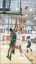  ?? Tim Godbee ?? Calhoun forward Blaze Hammett bangs into an Adairsvill­e defender after securing a rebound against the Tigers.