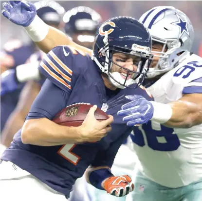  ?? | AP ?? Bears quarterbac­k Brian Hoyer, playing in place of injured Jay Cutler, is sacked Sunday by the Cowboys’ Tyrone Crawford.