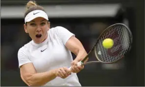  ?? (AP/Kirsty Wiggleswor­th) ?? Simona Halep of Romania defeated American Amanda Anisimova 6-2, 6-4 on Wednesday to advance to the women’s singles semifinals at Wimbledon.