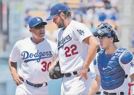  ?? Lisa Blumenfeld Getty Images ?? EVERYTHING CHANGED for the Dodgers on Sunday when Clayton Kershaw, center, left the game against the Atlanta Braves after two innings because of a back injury. Manager Dave Roberts, left, is among those hoping management will make a deal to add pitching.