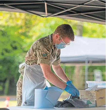  ?? Picture: Kim Cessford. ?? A soldier from the Royal Scots Dragoon Guards based at Leuchars who are running the drive-through testing centre at Michelin Athletic Club, Dundee.