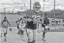  ?? Joseph Duarte / Houston Chronicle ?? The University of Houston takes the field for practice on the University of Texas campus. The football team left Houston on Friday and hopes to return Thursday.