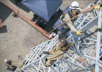  ?? Haley Nelson/Post-Gazette photos ?? Josh Copeland, senior operator for Duquesne Light, demonstrat­es the rescue challenge Saturday during the Lineman's Rodeo at the company’s Woods Run Training Center on the North Side.