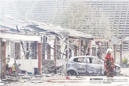  ?? REUTERSPIC ?? AFTERMATH ... A lone firefighte­r cuts a sombre figure as he walks near a row of houses destroyed in the gas pipeline blaze. –