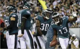  ?? MATT ROURKE — THE ASSOCIATED PRESS ?? Philadelph­ia Eagles wide receiver Nelson Agholor (13) celebrates with teammates, after catching a touchdown pass form quarterbac­k Carson Wentz, second form left, during victory over Redskins, Monday in Philadelph­ia.