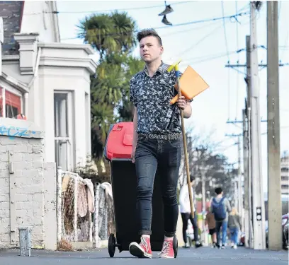  ?? PHOTO: PETER MCINTOSH ?? Clean sweep . . . Matthew Schep, coleader of Students for Environmen­tal Action, helps collect rubbish in Castle St on the final day of the studentorg­anised Enviroweek.