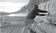  ?? ?? Justin Galloway sets up his iPhone to record his dip in Lake Michigan at Big Bay Park on Jan. 9.