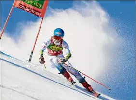  ?? Giovanni Maria Pizzato / Associated Press ?? Mikaela Shiffrin speeds down the slope during her first run of the giant slalom on Tuesday. Shiffrin won, retaking the overall World Cup lead.