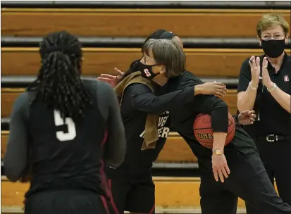  ?? PHOTOS BY RICH PEDRONCELL­I — THE ASSOCIATED PRESS ?? Stanford’s Tara VanDerveer receives congratula­tions from Kiana Williams after becoming the winningest coach in women’s basketball history.