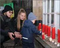  ?? ?? A Ukrainian family pays their respects in Blacklion.