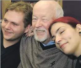  ?? RICHARD ARLESS JR ?? Father Emmett Johns, centre, celebrates in 2009 with clients Stewart and Karine at the headquarte­rs of Dans la rue as the organizati­on marked its 15th anniversar­y. The program started out of a van providing hot drinks and food for street kids. It now...