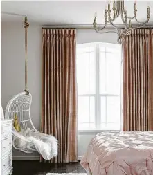  ?? Colleen Scott Photograph­y ?? Hanging swing chairs are popular with tween and teen girls. Nikole Starr Interiors added one to this bedroom corner.