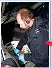 ??  ?? right, an officer checks the boot of a car