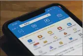  ?? NG HAN GUAN — THE ASSOCIATED PRESS FILE ?? The app for Alipay, the mobile payments service operated by Ant Group, is seen on a smartphone in Beijing.