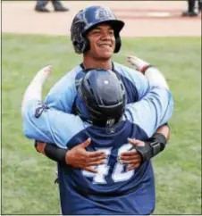  ?? JOHN BLAINE — FOR THE TRENTONIAN ?? Thunder’s Thairo Estrada, back, hugs bat boy Tommy Smith, front, after scoring a run in the fourth inning of a game against Erie. Estrada ranks second in the Eastern League in hits and third in batting average.