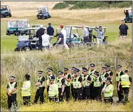  ?? AP/PETER MORRISON ?? Security is tight Saturday as President Donald Trump plays golf at Trump Turnberry, a luxury resort in Turnberry, Scotland. Nearby protesters chanted “No Trump, no KKK, no racist USA” as he teed off Saturday. Thousands more demonstrat­ed against the U.S. president in Edinburgh.