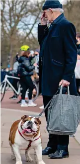  ??  ?? Bulldog spirit: A mourner in London