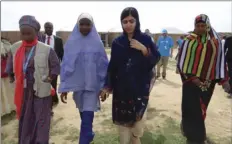  ?? PHOTO/ JOSSY OLA ?? Pakistani activist Malala Yousafzai (center right), is welcomed by students and a staff from UNICEFF during a visit to the camp of people displaced by Islamist extremist in Maiduguri Nigeria on Tuesday. AP