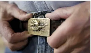  ?? NWA Democrat-Gazette/DAVID GOTTSCHALK ?? One-of-a-kind belt buckles have been created by Hank Kaminsky for decades. He used to sell them at the Fayettevil­le Farmers Market.