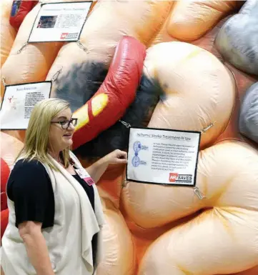  ?? ARKANSAS DEMOCRATGAZETTE FILE PHOTO ?? Marcela Backus, nurse educator for the University of Arkansas for Medical Sciences, shows off the hospital’s inflatable Mega Brain, which illustrate­s the brain’s structure and provides informatio­n about strokes and brain injuries and diseases.