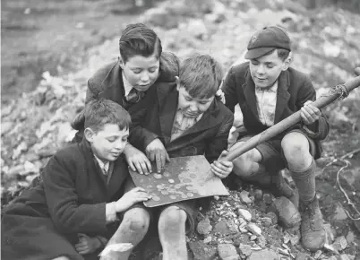  ??  ?? Putting the effort in to save money can really pay off. These boys found £3 10s on a rubbish dump at Penrhiwtyn, near Neath, in 1937