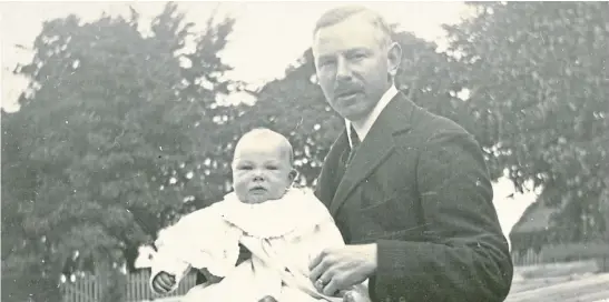  ??  ?? The late Dundee businessma­n James Ernest Cox, of jute company Cox Brothers, is pictured here with his first son, David Ernest Cox, in July 1909. The picture is courtesy of Dundee University Archives, which has access to the Cox family papers and photos.