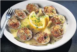  ?? SUSAN STOCKER/SUN SENTINEL ?? Gianni’s Ristorante in Pompano Beach celebrates its 30th anniversar­y this year. Baked clams oreganato has been on the menu since it opened in 1989.