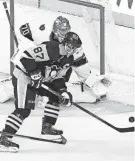  ?? DARREN CALABRESE/CANADIAN PRESS VIA AP ?? Penguins center Sidney Crosby is stopped by Senators goaltender Joonas Korpisalo during a preseason game Oct. 2 in Halifax, Nova Scotia.