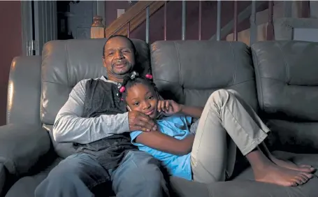  ?? Photos by Kathryn Scott, The Denver Post ?? Ralph Ford sits with his granddaugh­ter Alaysia Simpson, 8. Ford’s granddaugh­ter and her three sisters came to live with him after the slaying of his daughter, Clarissa, who is Alaysia’s mother.