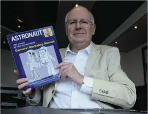  ??  ?? PRAISED: Ken MacTaggart with his book Astronaut Owners’Workshop Manual