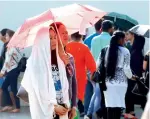  ??  ?? Residents bear the scorching heat to reach the churches and attend special prayers.