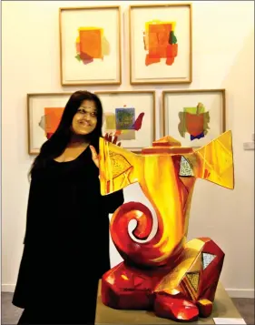  ?? A visitor poses next to an art exhibit at the India Art Fair at NSIC Ground,Okhla, in New Delhi, on Saturday. PHOTO: ABHISHEK SHUKLA ??