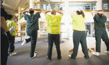  ?? Noah Berger / Special to The Chronicle ?? A guard (partly obscured at left) searches women returning to a residentia­l building at the West County Detention Facility in Richmond in October. Several female inmates have complained of harsh conditions.