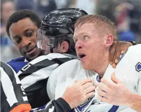  ?? NATHAN DENETTE/AP ?? Lightning forward Corey Perry, right, and Maple Leafs forward Wayne Simmonds are separated by officials in the third period Monday.