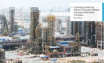  ?? Bloomberg ?? Cracking towers at Adnoc’s Ruwais refinery and petrochemi­cal complex.