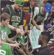  ?? STAFF PHOTO BY CHRISTOPHE­R EVANS ?? FAN FAVORITE: Semi Ojeleye, shown signing autographs before a Celtics playoff game, is one of the leaders on the summer-league team in Las Vegas.