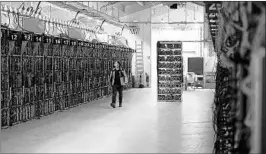  ?? EGILL BJARNASON/AP ?? Computer rigs “mine” bitcoin inside the Genesis Mining cryptocurr­ency mine in Keflavik.