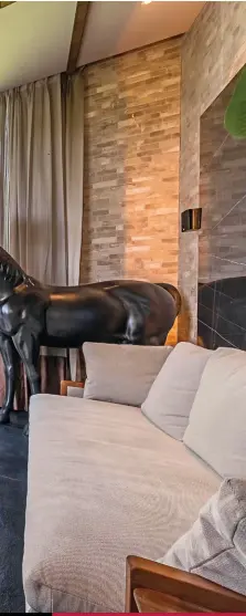  ??  ?? NO HORSING AROUND You cant miss the life-size horse lamp that dominates the living room (above); the exterior of the home (right)