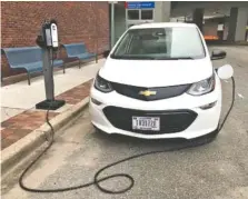  ?? STAFF PHOTO BY ROBIN RUDD ?? A Tennessee Valley Authority Chevrolet Bolt charges outside the federal utility’s Missionary Ridge office complex on Broad Street last week.