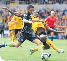  ??  ?? Manchester City’s Bernardo Silva battles for possession with Willy Boly (Wolves)