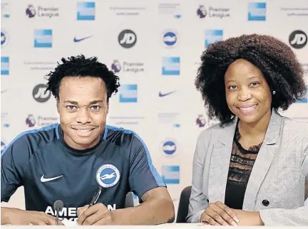  ?? / BHAFC ?? Percy Tau and his agent Mmatsatsi Sefalafala during the completion of the former Mamelodi Sundowns star’s record-breaking move to English Premier League side Brighton &amp; Hove Albion.