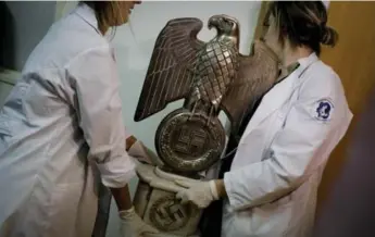  ?? NATACHA PISARENKO PHOTOS/ THE ASSOCIATED PRESS ?? This Nazi statue, which was hidden in a house near Argentina’s capital, was discovered by police on June 8.