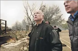  ?? Carolyn Cole Los Angeles Times ?? GOV. JERRY BROWN, center, and U.S. Secretary of the Interior Ryan Zinke on Wednesday survey damage done to Paradise Elementary School by the Camp fire.