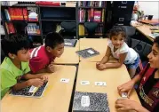  ?? CONTRIBUTE­D ?? Volunteer AIS fifth-grader Cameron Davoudi (far right) works with youngsters from Garden Hills Elementary as part of the AIS Horizons summer program.