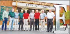  ?? Photo by Beth Hall ?? A group of Bank of Gravette and Legacy National Bank board members pose with the giant “E” which has been seen around Gravette recently. Pictured are Brian Glenn, Bank of Gravette president; board of directors members Loyd Swope, David Harris, and Steve Stafford; Patrick Swope, president and CEO, Legacy National Bank; Gary Jech, board of directors; Don Gibson, CEO emeritus, Legacy National Bank; Matt Mawby, board of directors; and Gary George, chairman of the board.