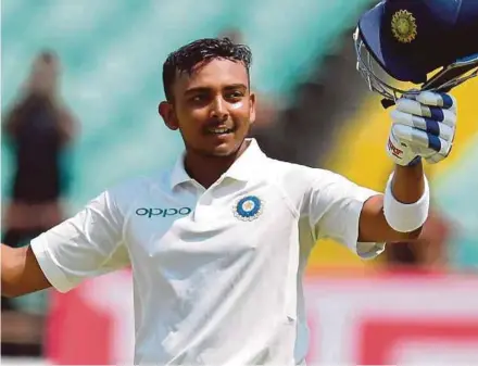  ?? AFP PIC ?? Prithvi Shaw celebrates scoring a century in the first Test match between India and West Indies in Rajkot yesterday.
