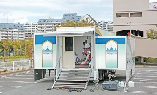  ?? JAPAN NEWS-YOMIURI PHOTO ?? Men pray in a 48-square-metre room in the back of a truck that serves as a mobile mosque. It’s even equipped with four air conditione­rs.