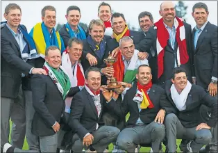  ??  ?? Paul Mcginley’s victorious Ryder Cup squad celebrates their success at Gleneagles in 2014