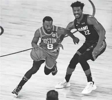  ?? KIM KLEMENT/USA TODAY SPORTS ?? Celtics guard Kemba Walker (8) drives against Heat forward Jimmy Butler during Game 3 of the Eastern Conference finals on Saturday.