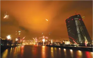  ??  ?? Fireworks explode in front of the European Central Bank during New Year’s Eve celebratio­ns in Frankfurt. Analysts cite the super-cheap monetary policy pursued by the ECB as one factor behind the burgeoning recovery in the EU which has not been accompanie­d by a correspond­ing pickup in inflation. (Reuters)